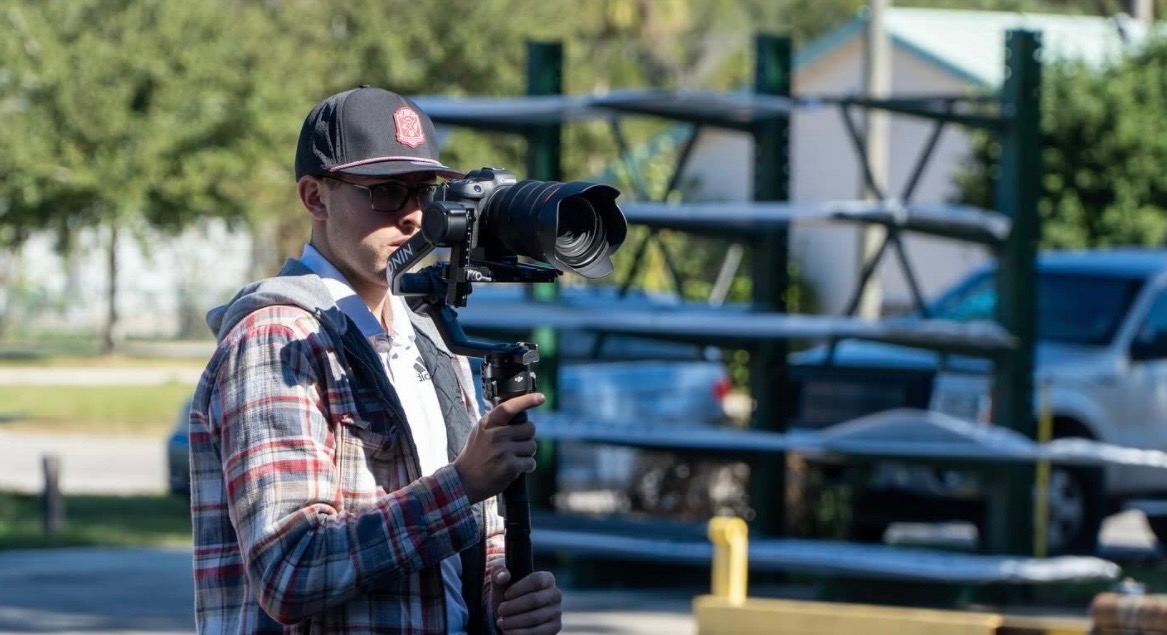 Aidan operating a gimbal rig outdoors