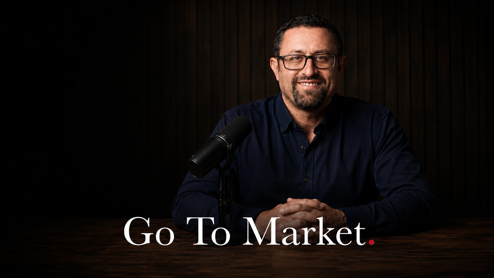 Adam Fridman, host of Go to Market, at the advisor.tv studio table.