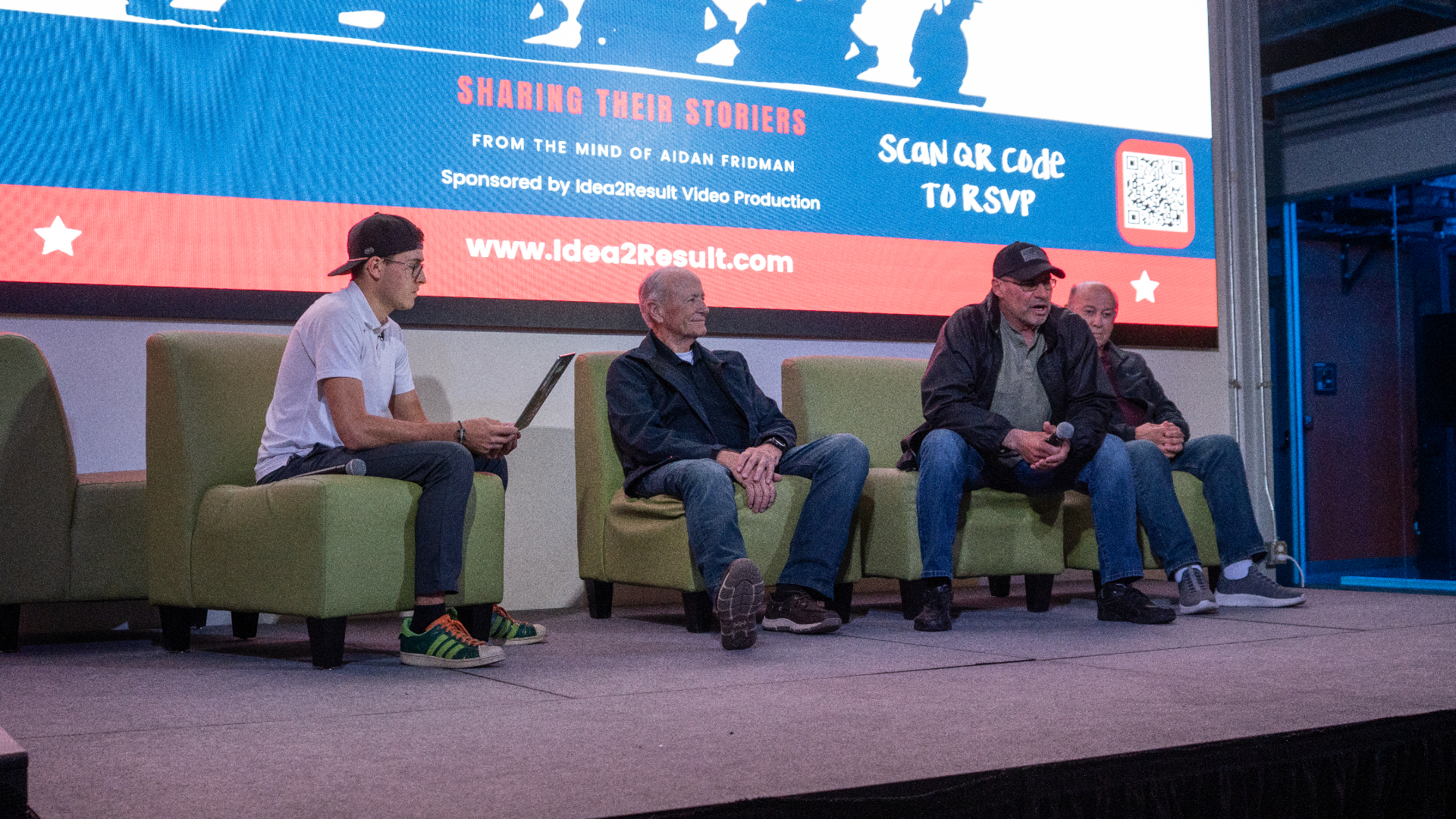 Aidan hosting a live panel on stage