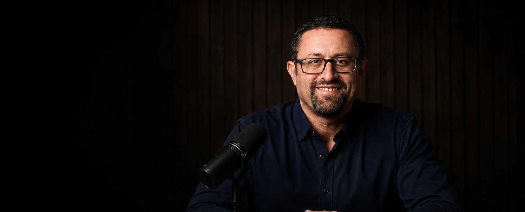 Adam Fridman, host of What We Pass On, at the advisor.TV studio table.